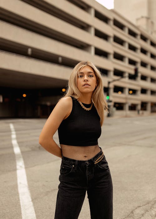 A Blonde Woman in Black Crop Top Standing on the Street
