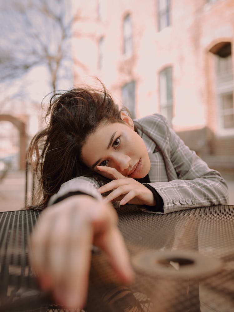 Beautiful Woman Leaning On A Table