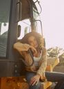 Woman in White Long Sleeve Shirt and Brown Pants Sitting on Black Truck