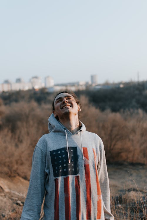 A Man in Gray Hoodie Sweater Smiling while Looking Up