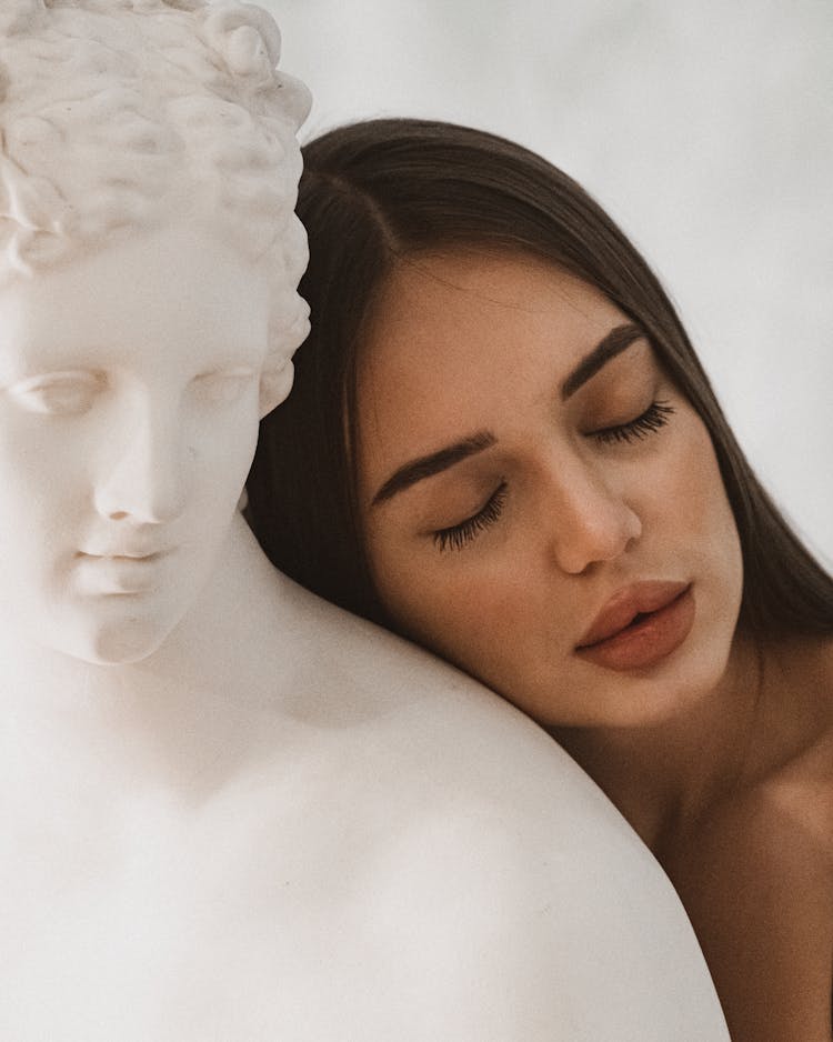 A Woman Hugging A Statue