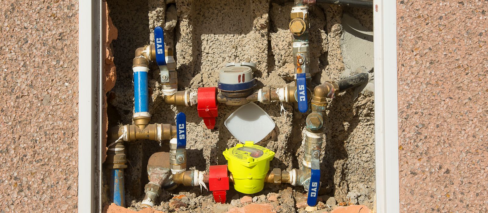 Water meters and supply lines in a wall