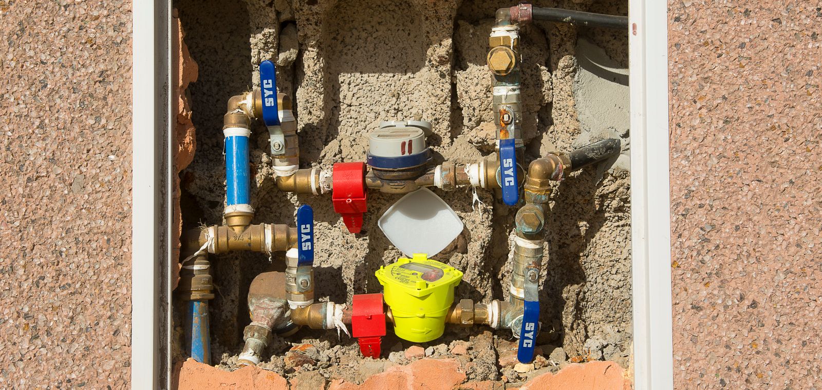 Water meters and supply lines in a wall