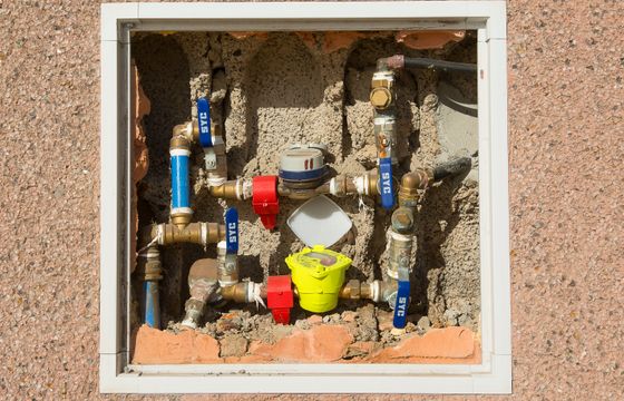 Water meters and supply lines in a wall