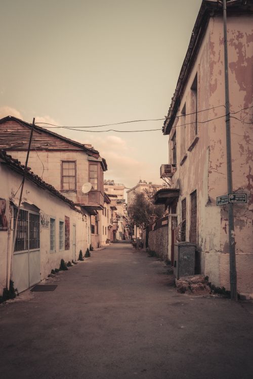 Free Charming narrow alleyway with vintage facades and rustic architecture, evoking a nostalgic feel. Stock Photo