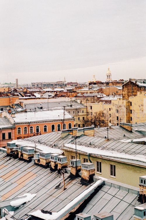 Free Scenic aerial view of snow-covered rooftops in a bustling urban landscape. Stock Photo