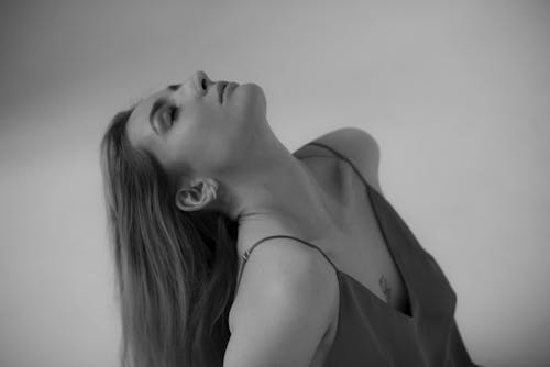 Photo of a Woman Tilting Her Head Back