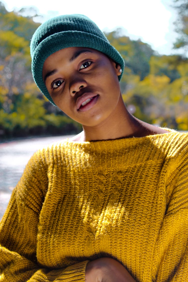 Woman Wearing Yellow Knit Sweater And Blue Knit Hat