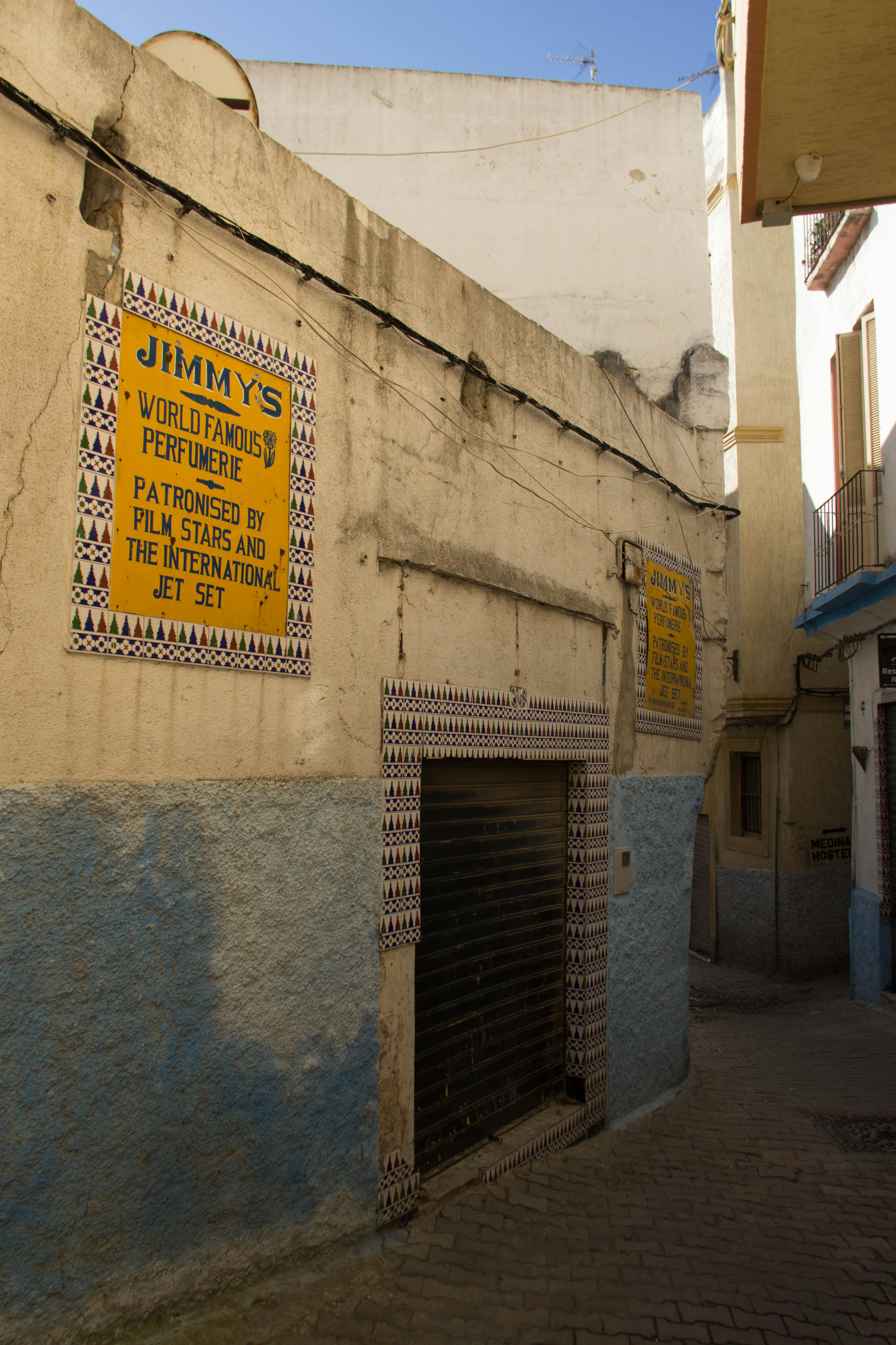 Charming alley in Tangier showcasing traditional architecture and local signage.