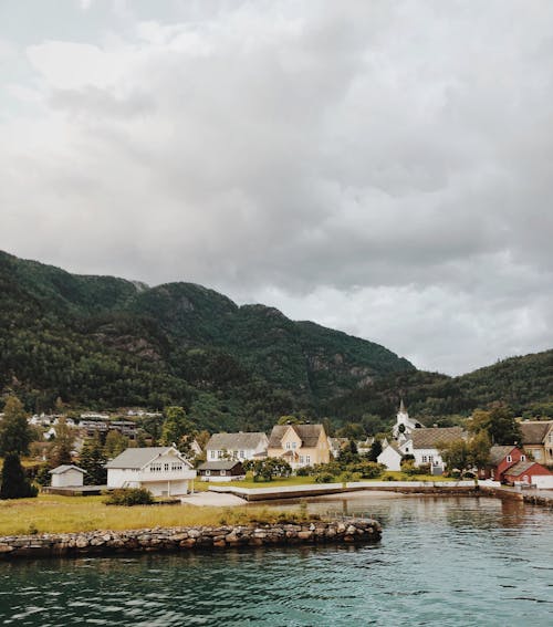 Houses near Mountains under the Cloudy Sky