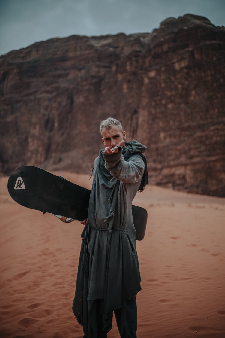 A Man Carrying A Sandboard 