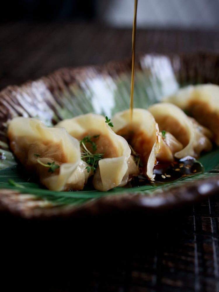 Pouring Sauce On Gyoza Dumplings