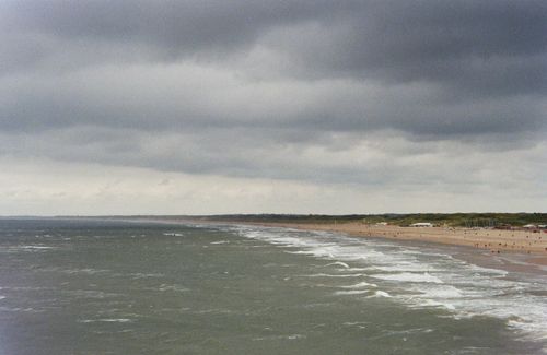 Free Gloomy beach scene with waves crashing onto sandy shores at The Hague, Netherlands. Stock Photo