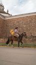 Joselo riding his horse through town.