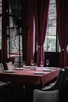 Upscale dining setup with wine glasses and plates in a stylish Baku restaurant interior.
