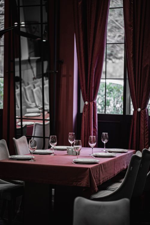 Free Upscale dining setup with wine glasses and plates in a stylish Baku restaurant interior. Stock Photo