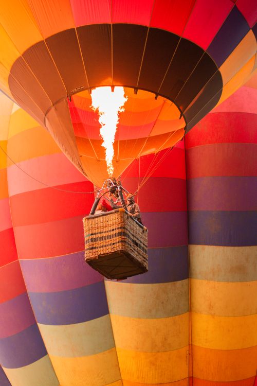 Free Vibrant hot air balloon soaring in Brazil with vivid flames and colorful stripes. Stock Photo