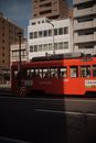 Red and White Tram on the Road