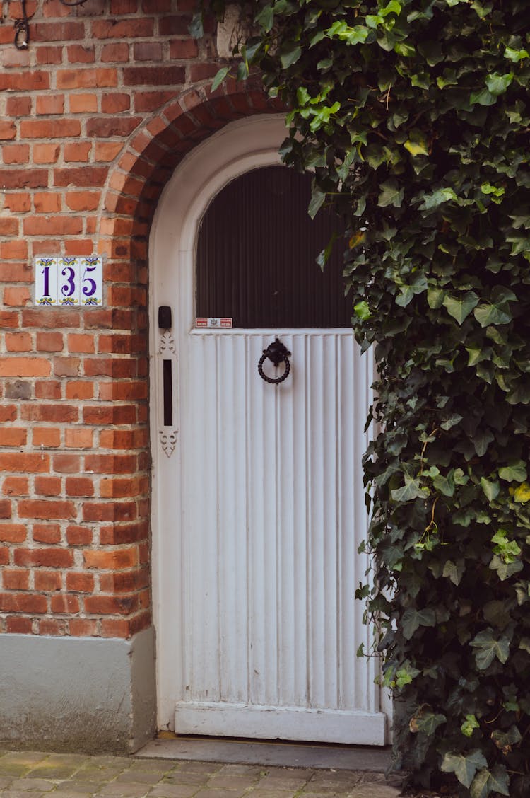 White Arched Door With Door Knocker