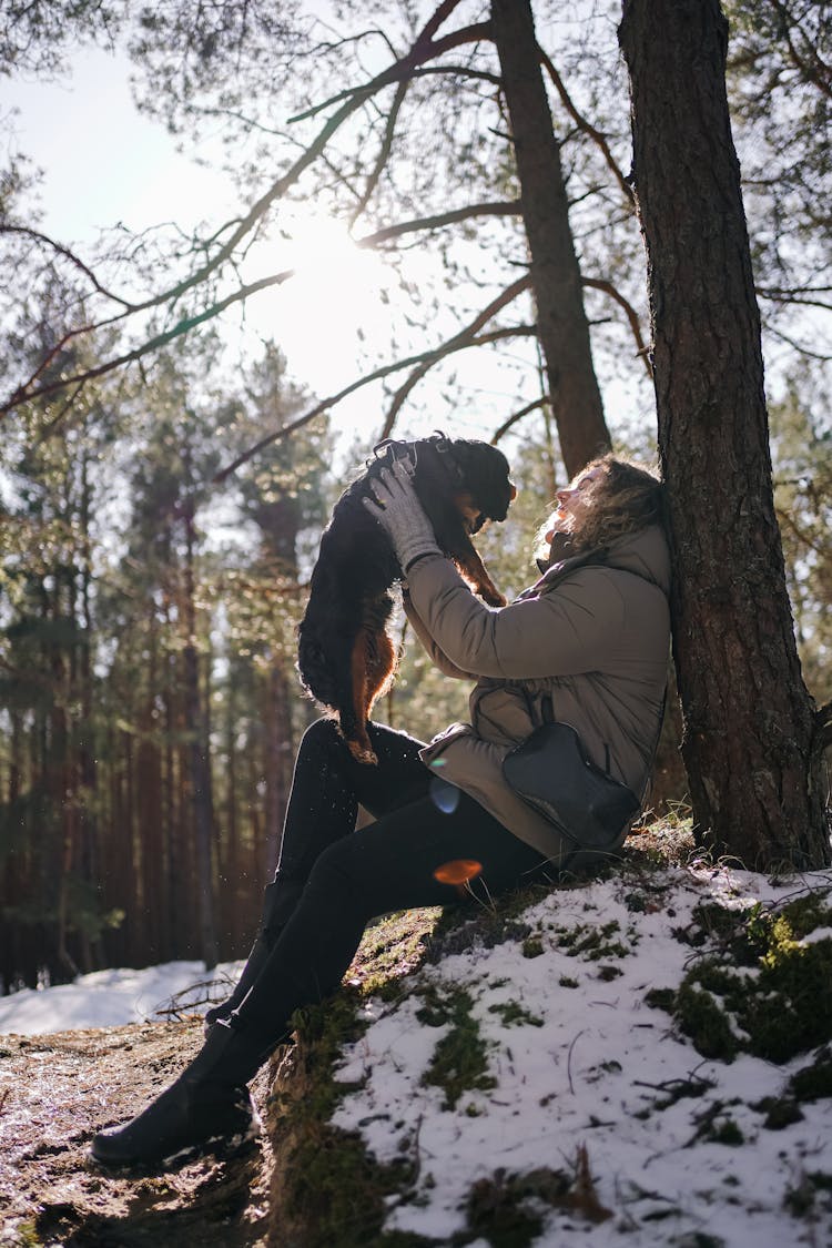 A Woman Playing With Her Pet Dog