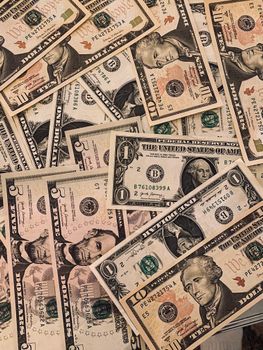 A collection of various US dollar banknotes arranged in an overlapping pattern.