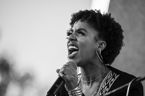 Free Grayscale Photo of a Woman Shouting at a Microphone Stock Photo