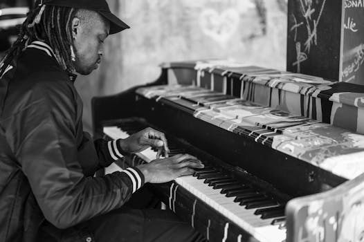 Captivating monochrome image of a man playing an urban street piano.