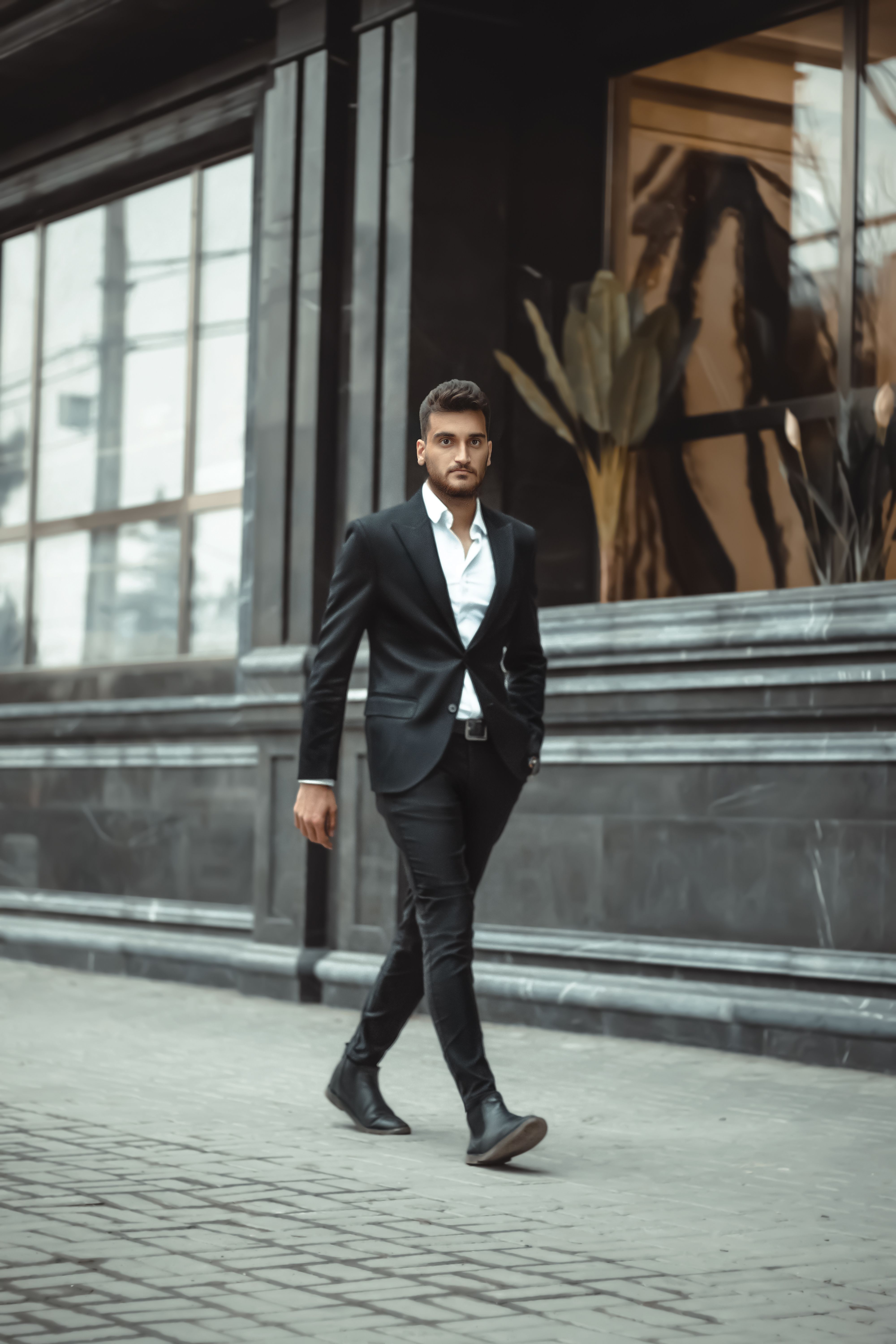 a man dressed in all black is walking Arriving in style