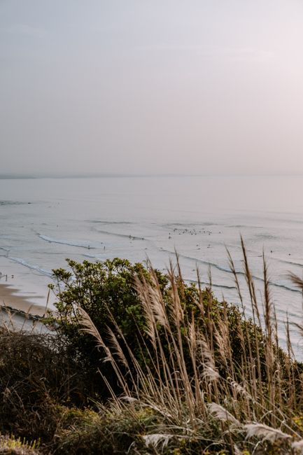 Peaceful view of Biarritz coastline with gentle waves and quiet shore at dusk.