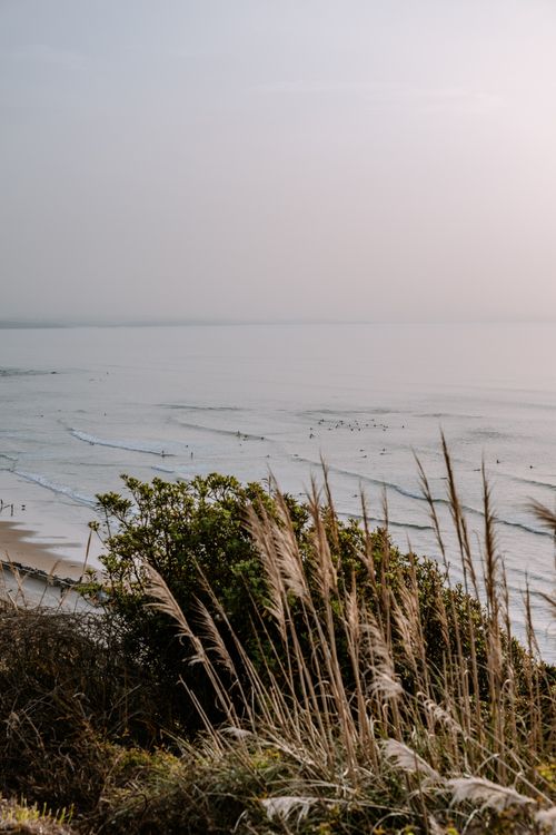 Free Peaceful view of Biarritz coastline with gentle waves and quiet shore at dusk. Stock Photo