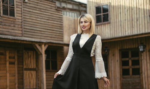 A Woman in Black and White Long Sleeve Dress