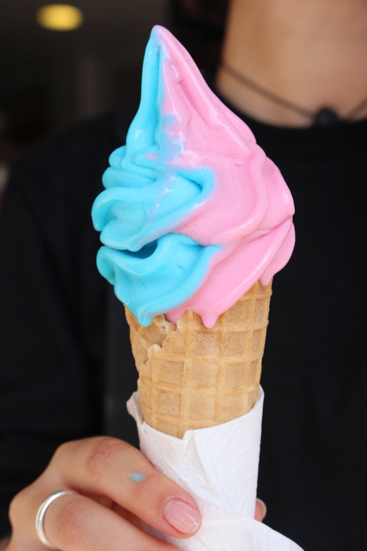 Blue And Pink Cone Ice Cream In Woman Hand