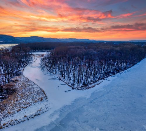 Free Breathtaking winter sunset over a snow-covered landscape in West Newton, Minnesota. Stock Photo