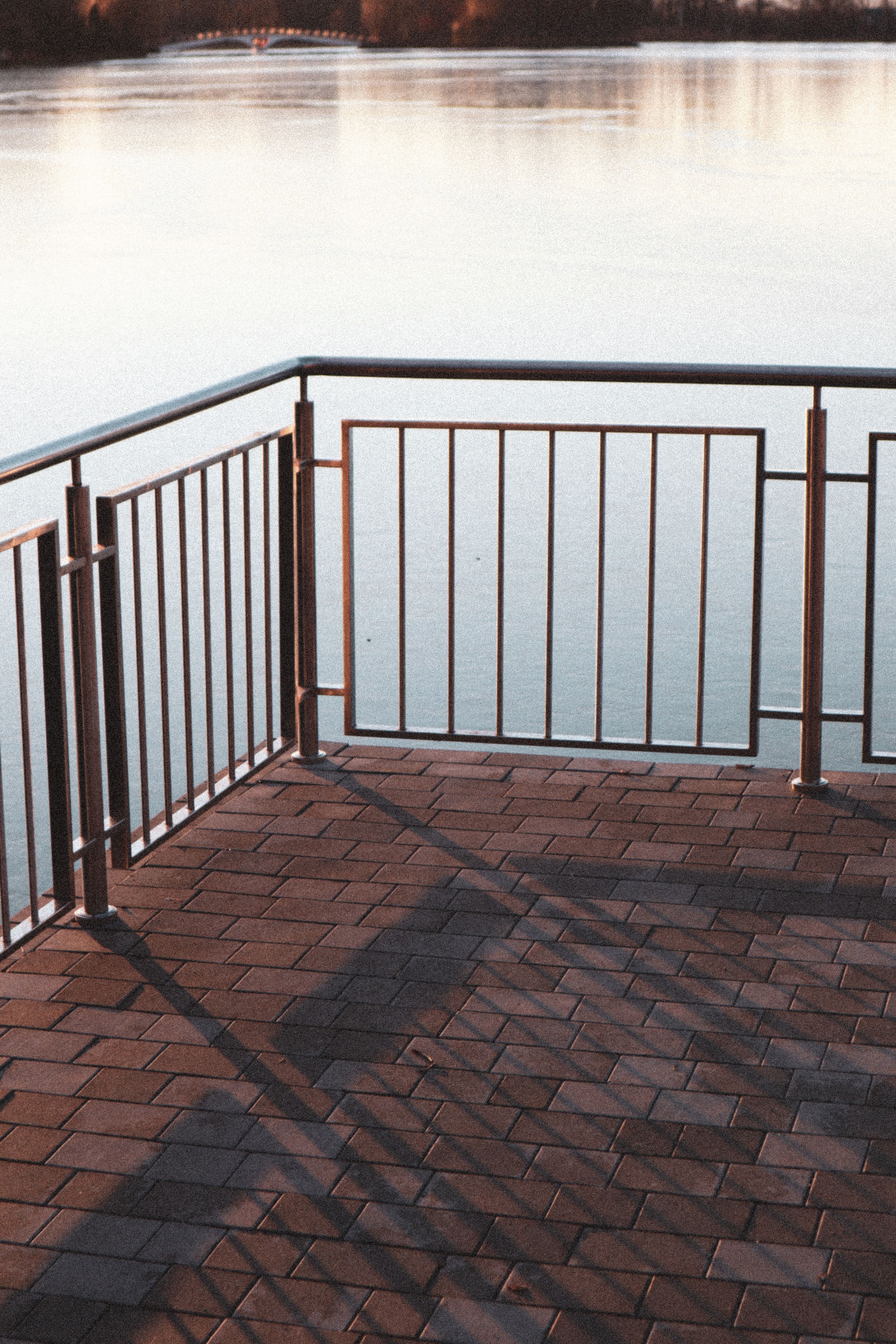 Black Metal Railings on Brown Brick Floor · Free Stock Photo