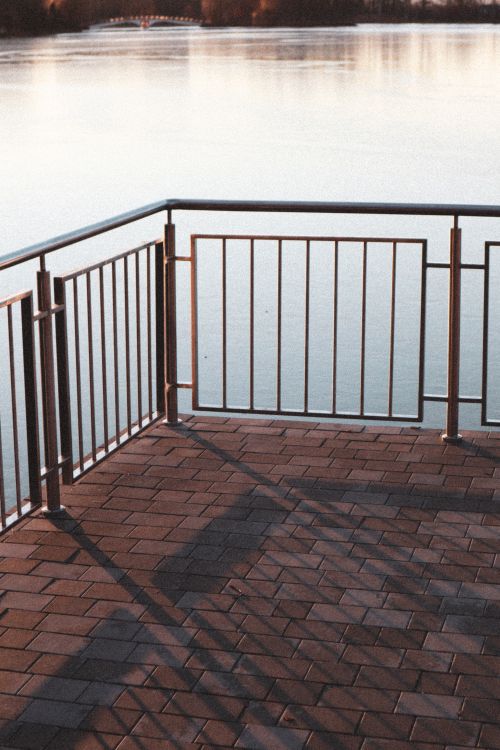 Black Metal Railings on Brown Brick Floor · Free Stock Photo