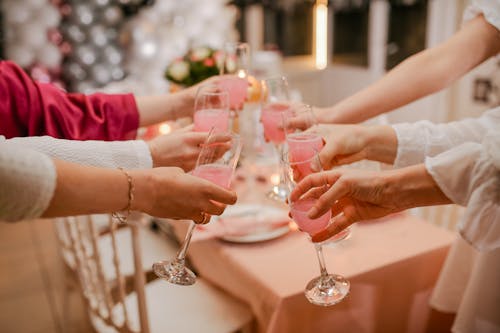 Free People Toasting Their Wine Glasses with Rose Wine Stock Photo