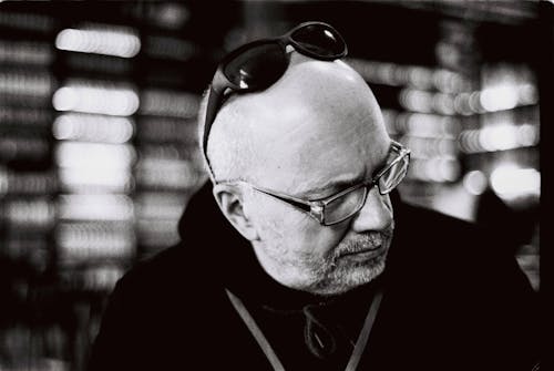 Grayscale Photo of a Man with Sunglasses on Head