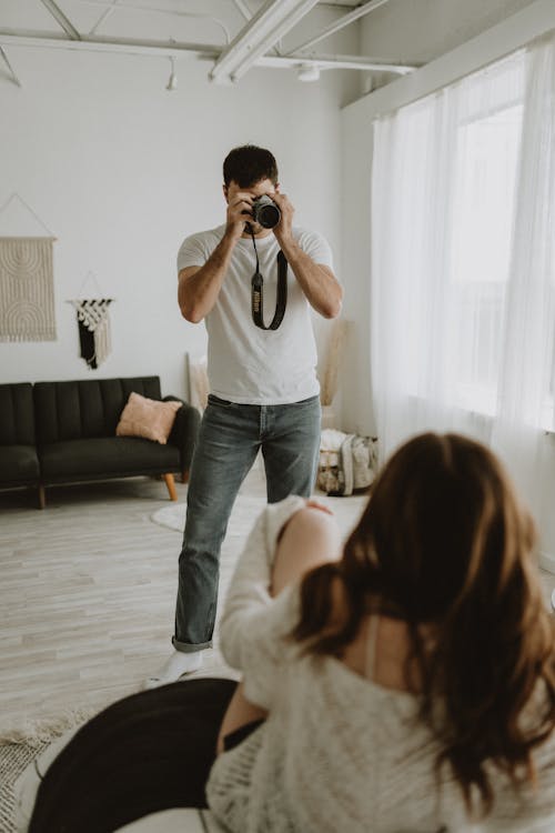 A Man in White Shirt Taking a Photo