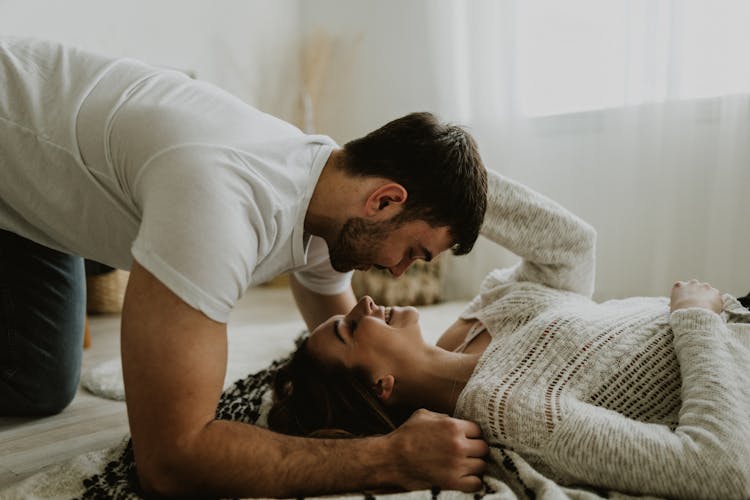 Young Couple Lying On Bed 