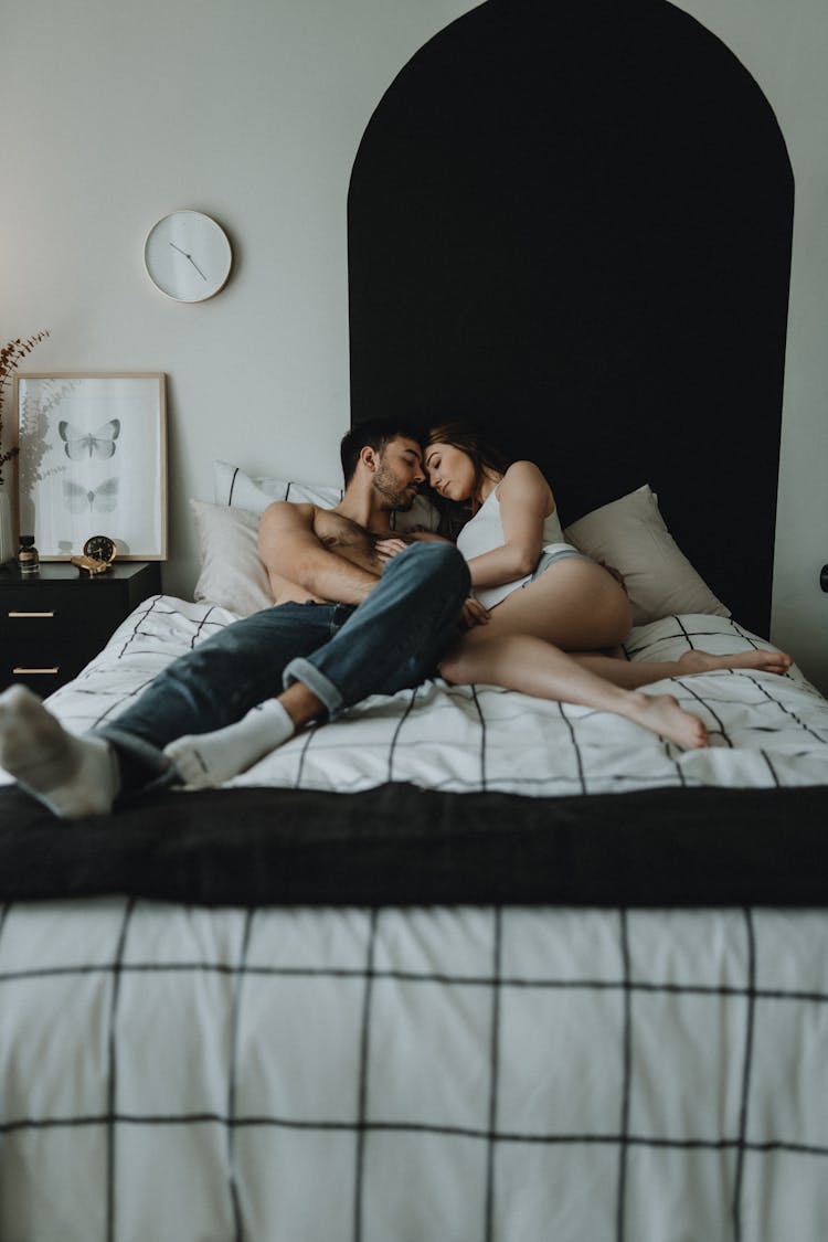 Young Couple Lying On Bed 