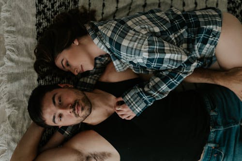 Free A Couple Lying in Bed  Stock Photo