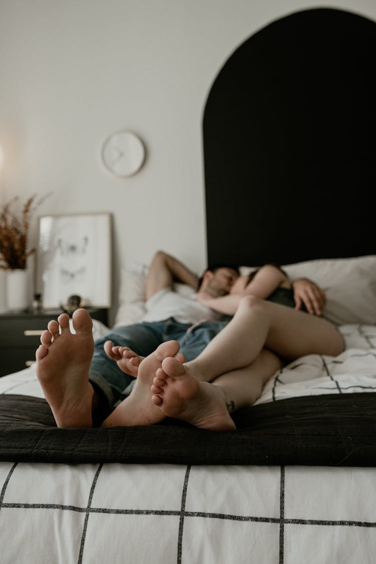 A Couple Lying In Bed 