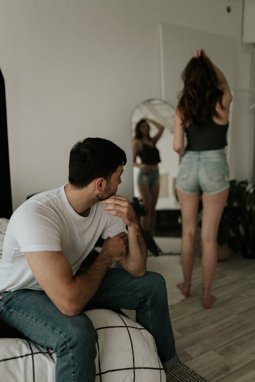 Man Looking at a Woman Who Is Looking at her Reflection 
