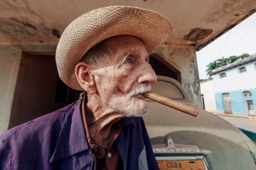 Photo of Old Cuban Man in Straw Hat and Cigar in Mouth 