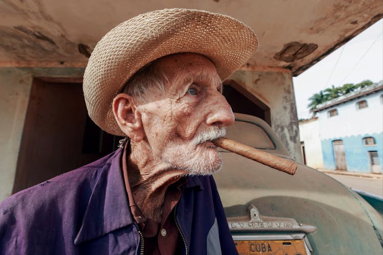 Photo Of Old Cuban Man In Straw Hat And Cigar In Mouth 