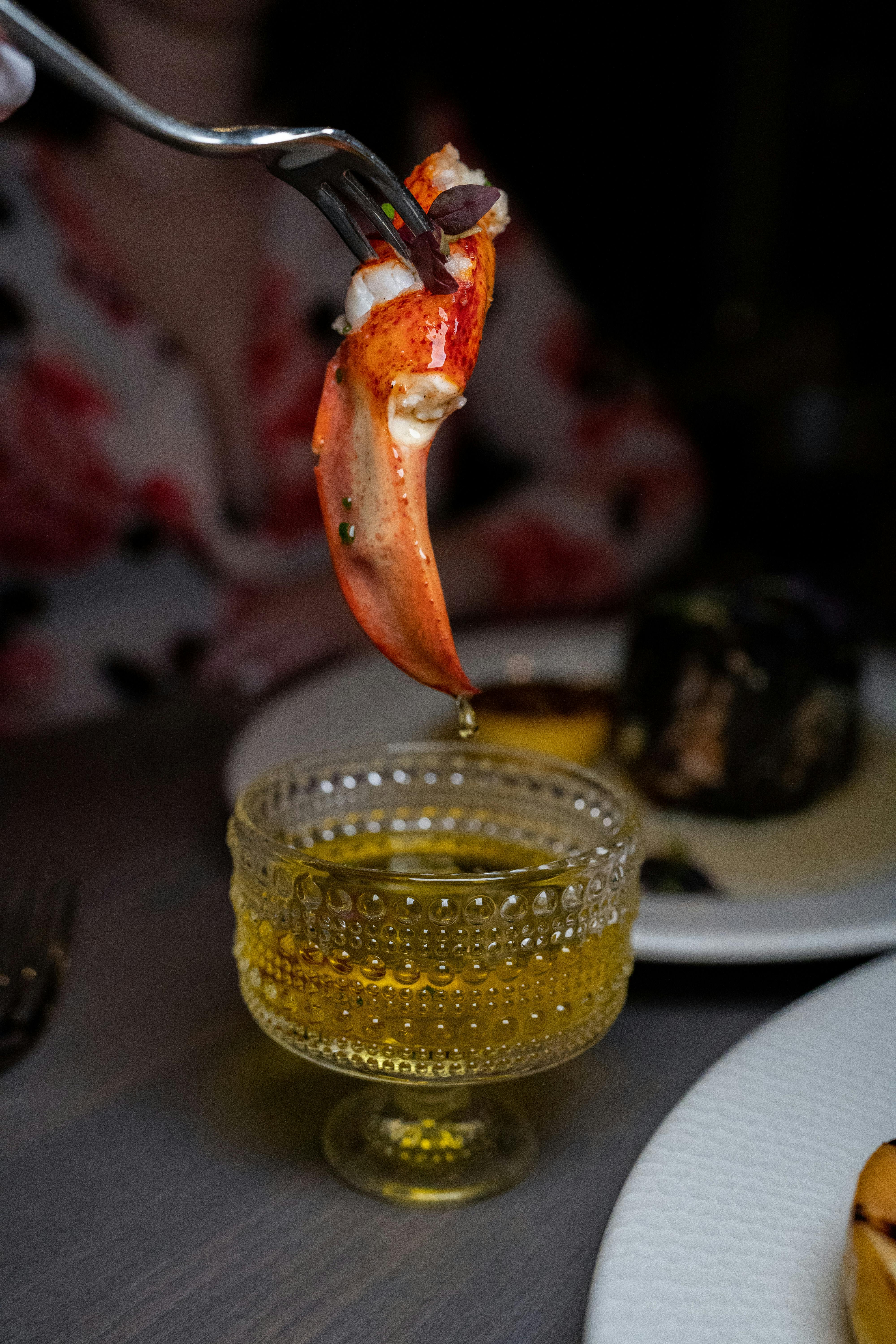 fish on fork over dish with liquid