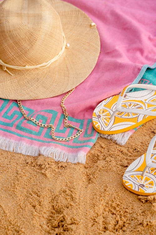 Free Yellow Flip-flops and a Straw Hat Stock Photo