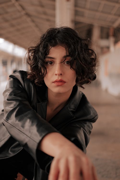 Shallow Focus of a Curly-Haired Woman in Black Leather Jacket