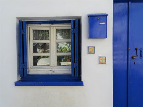 Free Blue Mailbox Mounted on Wall Stock Photo