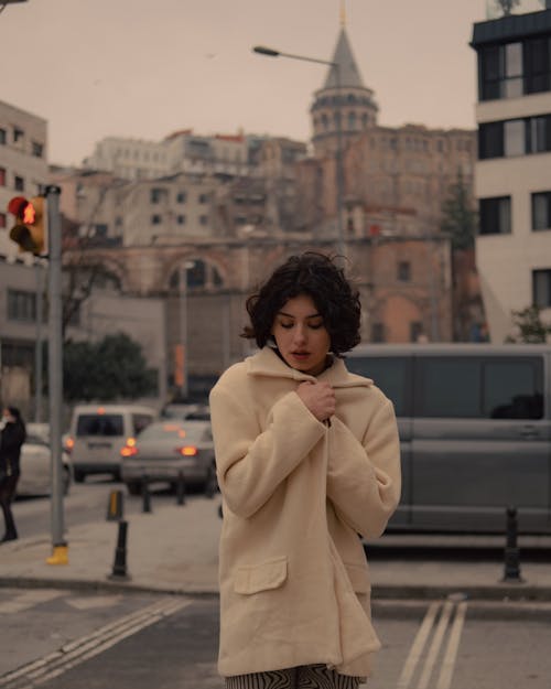 Shallow Focus of a Woman Wearing Beige Coat white Standing on the Street